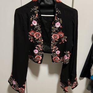 Black silk bolero style jacket.Beaded,in perfect condition. Long sleeve.